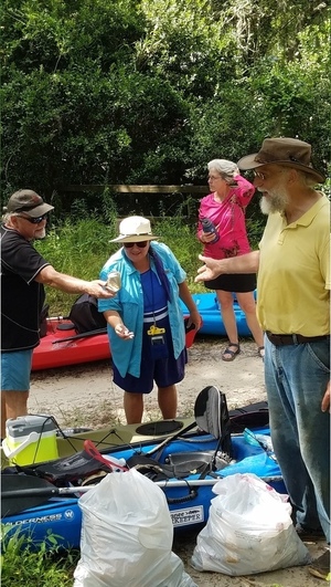 [Tom Potter (drink can), Julie Bowland (fishing float), Shirley Kokidko (puzzled expression), jsq with trash collected, 30.48012, -83.24482]