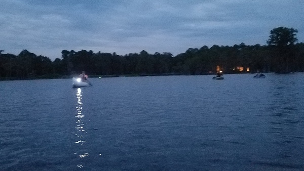 Paddlers and the lights of Banks Lake Outpost behind them