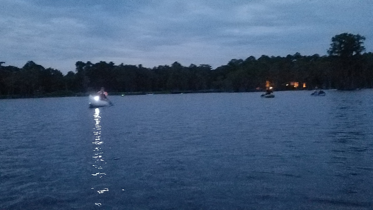 Paddlers and the lights of Banks Lake Outpost behind them