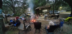 [Campfire circle listening to C.B. Adams]
