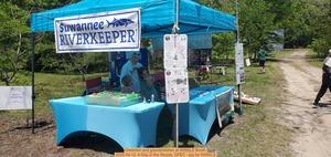 [Gretchen and grandchildren at WWALS Booth, 2025-04-12, A Day in the Woods, GFEC --jsq for WWALS]