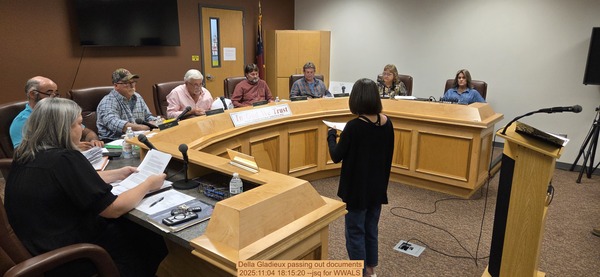 Della Gladieux passing out documents, 2025:11:04 18:15:20