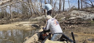 [David Savage moving debris while Phil Hubbard saws, 2026:02:14 12:27:07, 30.8629247, -83.3189509]