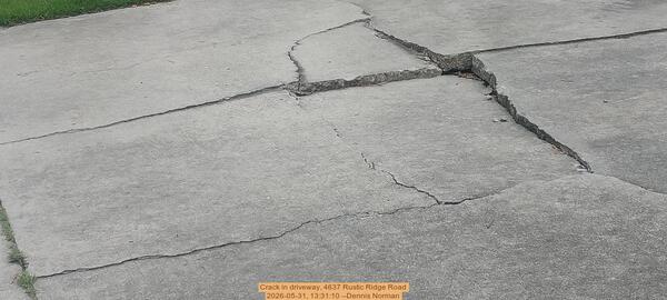 [Crack in driveway, 4637 Rustic Ridge Road 2026-05-31, 13:31:10 --Dennis Norman]