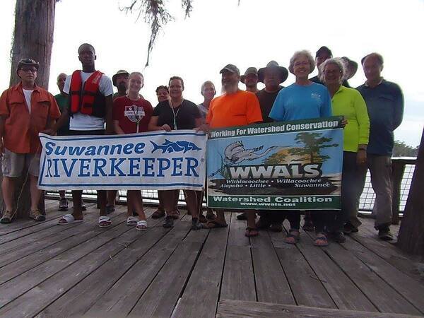 [Paddlers with WWALS and Suwannee Riverkeeper Banners]