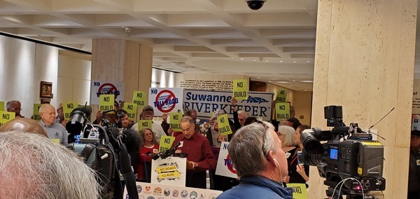 [Suwannee Riverkeeper John S. Quarterman beside banner; Mike Roth of OSFR speaking]