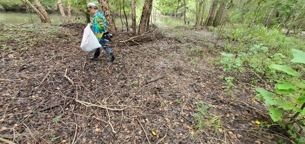 [Gretchen with a bag by the creek]