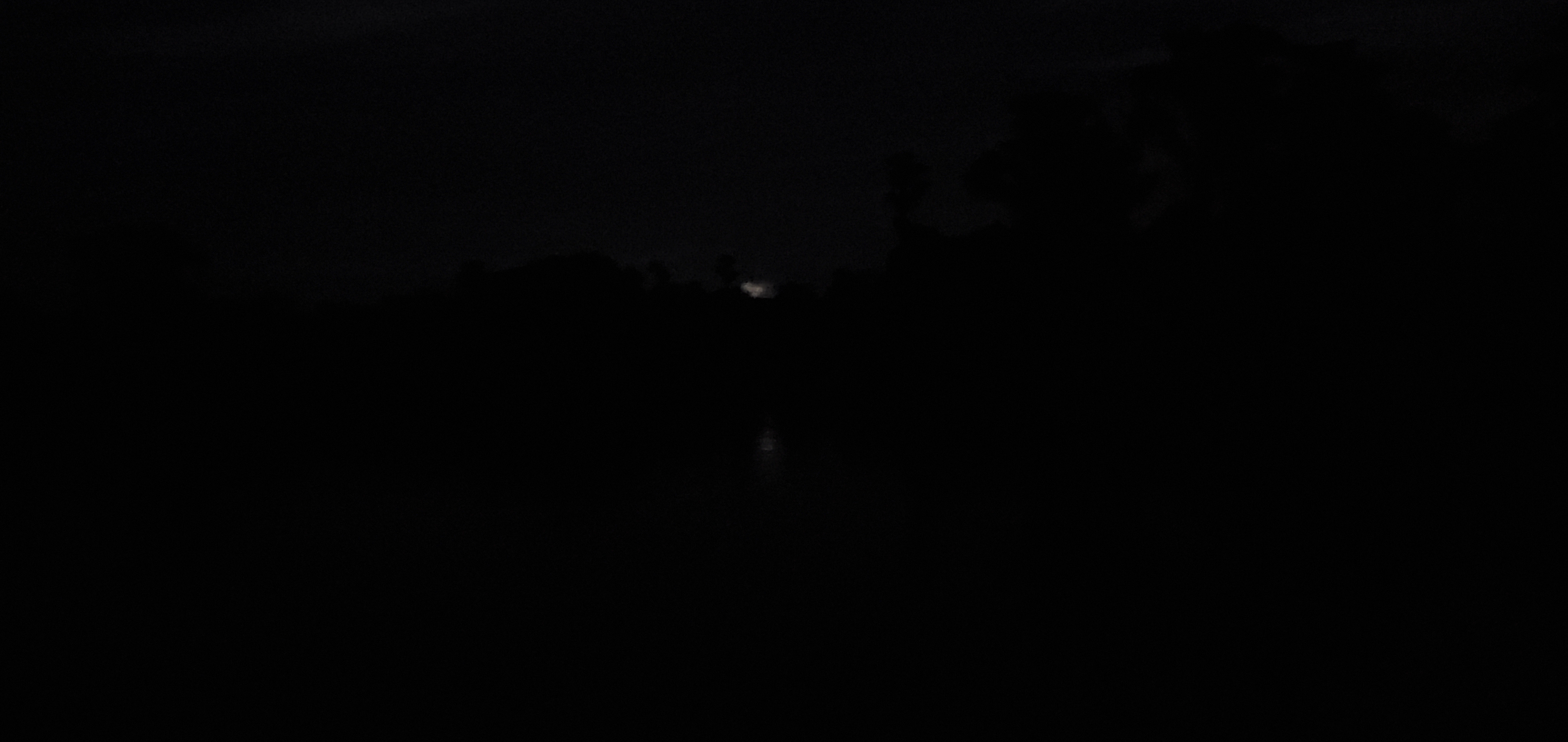 Dim moon through clouds
