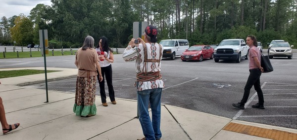 [Deb Haaland Assistant accepts Cherokee Tribe gift from MarthaJane Winkler, 12:50:44, 30.7389991, -82.1393612]