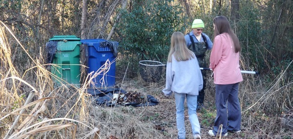 [Russell and relatives at the trash cans]