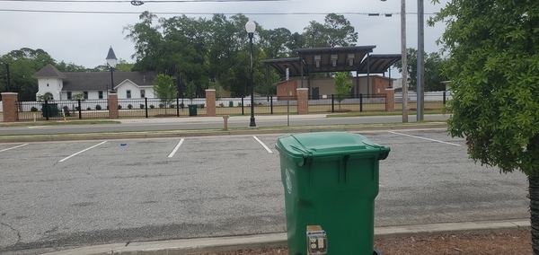 [Unity Park amphitheater and trash cans in parking lot]