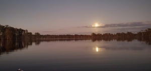 [Boats, moon above dark cloud]