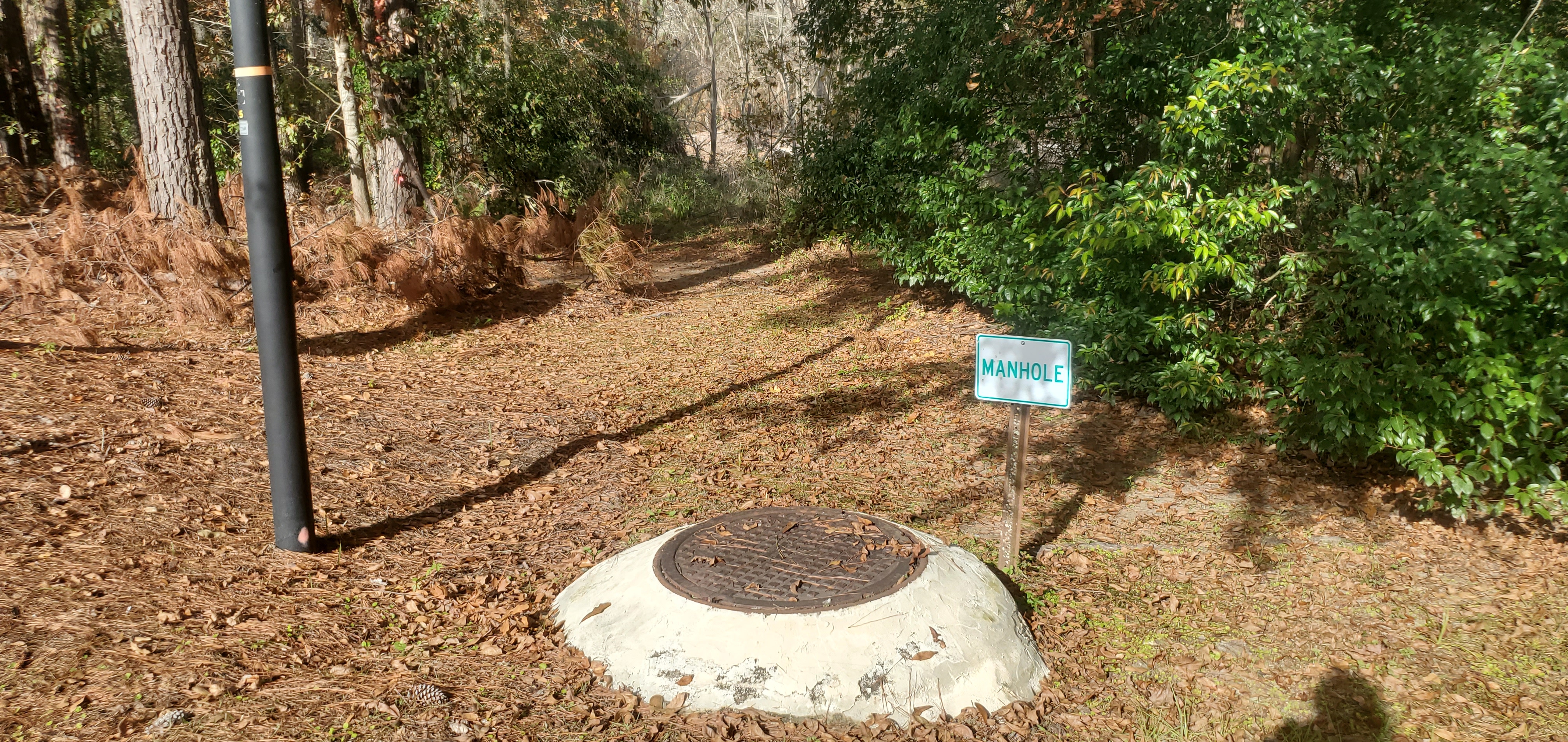Manhole sign to Sugar Creek, in front of Berta's Kitchen, 14:44:10, 30.8609749, -83.3183228