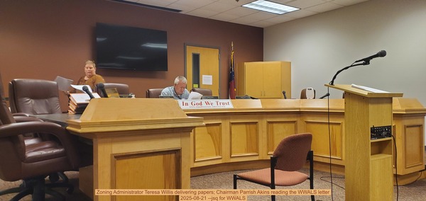 [Zoning Administrator Teresa Willis delivering papers; Chairman Parrish Akins reading the WWALS letter, 2025-08-21 --jsq for WWALS]
