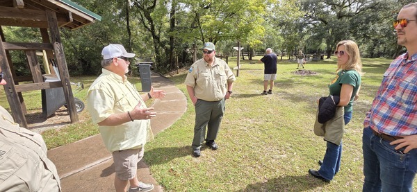 [Camp host in background, Adams Tract River Camp, 2025:09:27 11:32:19, 30.0349083, -83.0193395]