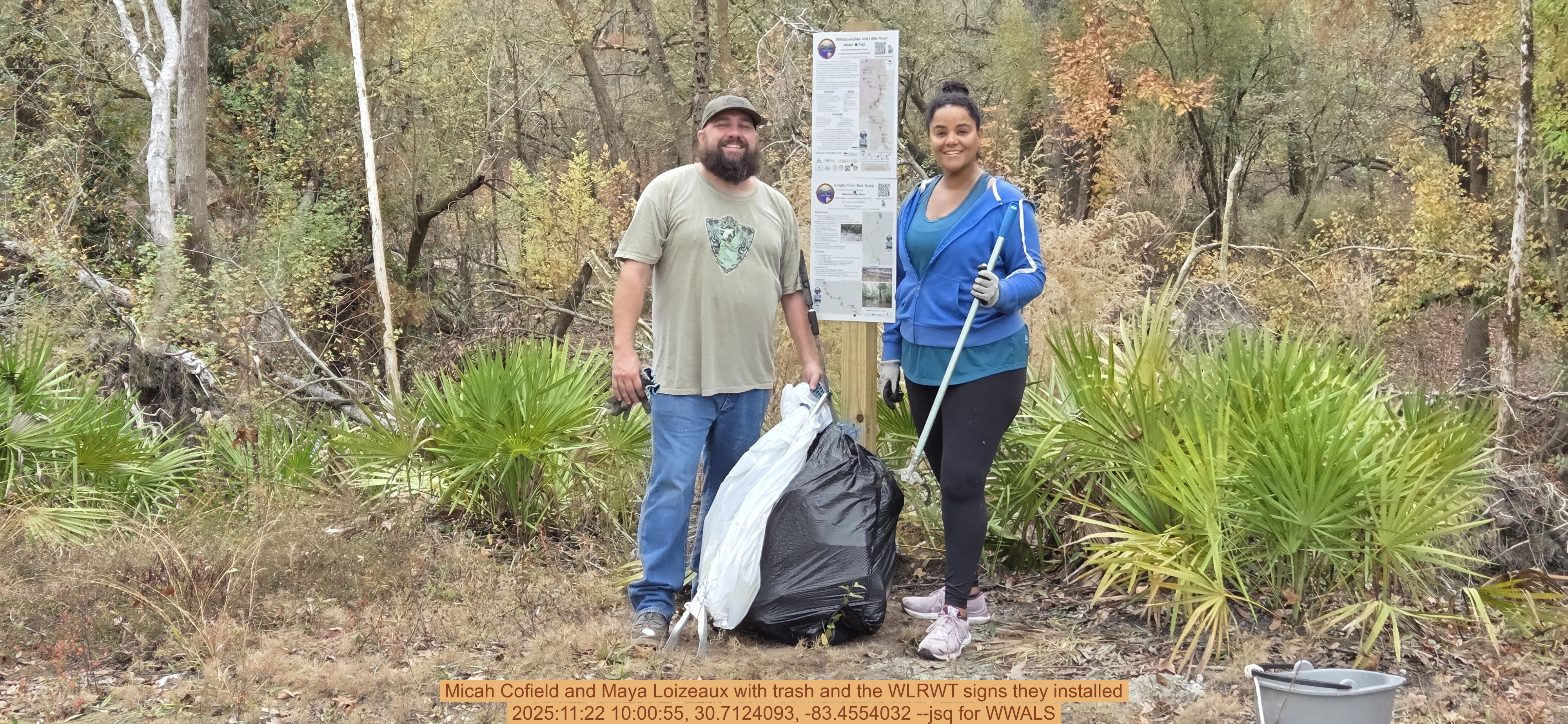 Micah Cofield and Maya Loizeaux with trash and the WLRWT signs they installed, 2025:11:22 10:00:55, 30.7124093, -83.4554032 --jsq for WWALS
