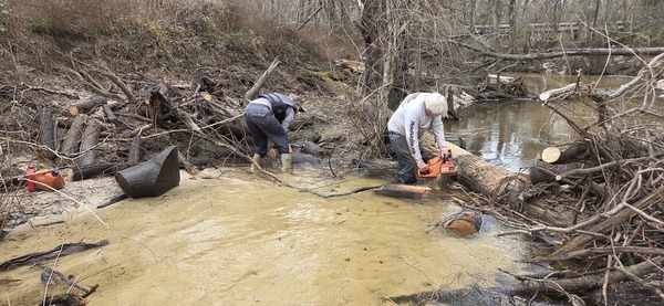 [Tish Hall moving logs; Phil Hubbard sawing, 2026:02:14 15:57:39, 30.8639055, -83.3210292]