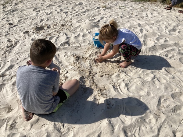 [Children playing in the sand]