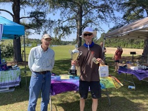 [Carl Fuller with trophy and $100]